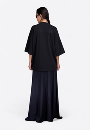 Model wearing crewneck oversized T-shirt, back view – East Vibe